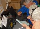 Joy Largent WB6VGZ helping Joe Cawrse KF7MEI learn to log on computer. 